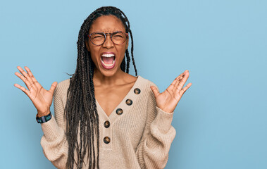 African american woman wearing casual clothes celebrating mad and crazy for success with arms...