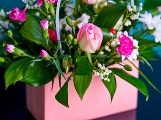 a bouquet of flowers is in a pink bag