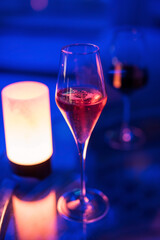 Red champagne glass at night club.  Luxury dinner