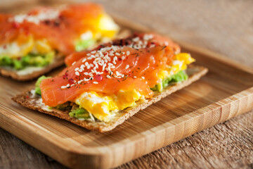 Salted salmon, scrambled eggs, avocado and cream cheese rye crisp toast