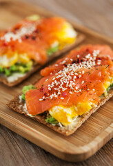 Salted salmon, scrambled eggs, avocado and cream cheese rye crisp toast