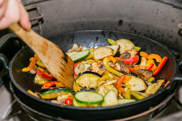 Chef prepares fresh vegetables on the grill. Close up