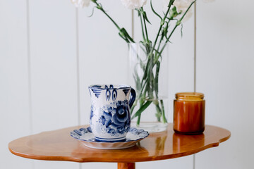 Porcelain cup with coffee on the table
