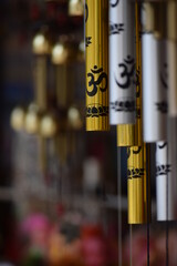 gold silver om inscribed wind chime