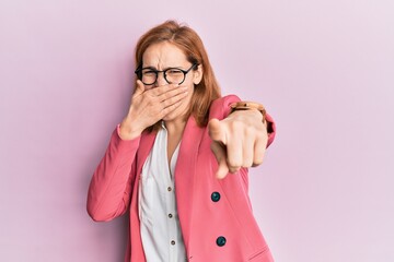 Young caucasian woman wearing business style and glasses laughing at you, pointing finger to the...
