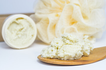 Shea butter on wooden spoon, beautiful, simple composition, unrefined, close up