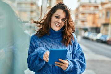 Young irish plus size girl using touchpad at the city.