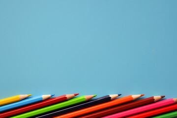 colored pencils on a blue background