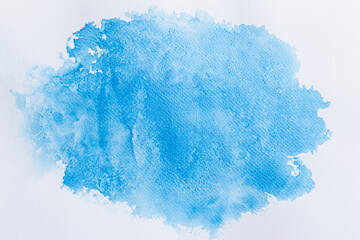 Blue watercolor stains on white paper. Abstract background.