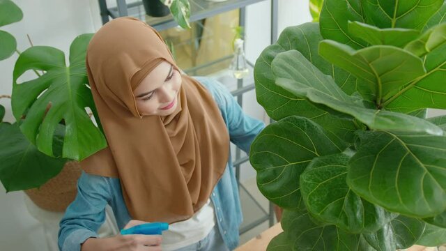 Happy young muslim woman enjoying  and relaxing leisure activity in garden at home