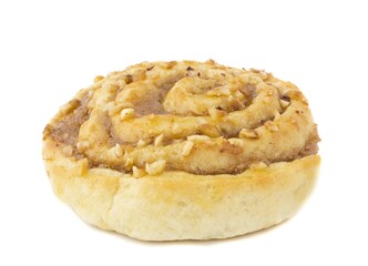 A spiral shaped sticky nut and cinnamon pastry cake on a white background