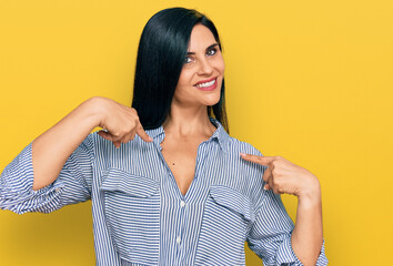 Young caucasian woman wearing casual clothes looking confident with smile on face, pointing oneself...