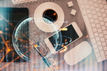 Double exposure of map hologram drawing over desktop. Top view. International connection concept.