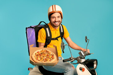 Young courier, pizza delivery man in uniform with thermo backpack on a moped isolated on blue background. Fast transport express home delivery. Online order.