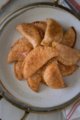 Closeup view of an elegant dish full of just fried homemade pasties.