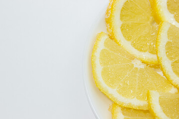 Fototapeta na wymiar Lemon in sugar. Lemon wedges sprinkled with sugar. Fruit in sugar