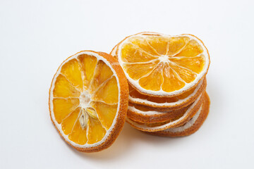 Dried orange on a white background. Round slices of dried orange. Dried fruit on a light background