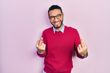 Hispanic man with beard wearing business shirt and glasses showing middle finger doing fuck you bad...