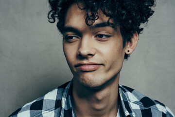 Obraz premium man with curly hair in plaid shirt portrait cropped view model emotions