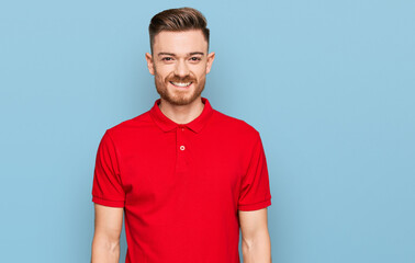 Young redhead man wearing casual clothes with a happy and cool smile on face. lucky person.