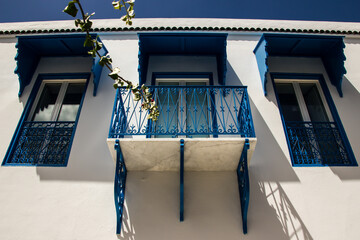 A bottom view of a beautiful blue and white villa in Sidi Bousaid in Tunis, with a nice balcony