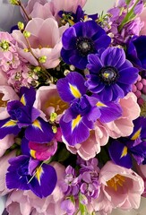 Beautiful fresh cut colorful bouquet. Pink peonies, purple irises. Flowers delivery, floral shop concept.	