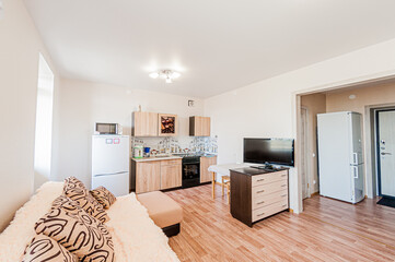 Russia, Moscow- April 28, 2020: interior room apartment bright cozy atmosphere. general cleaning, home decoration, preparation of house for sale. living room with sofa. lamp chandelier on the ceiling