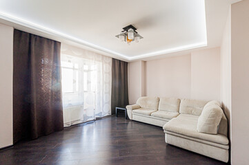 Russia, Moscow- April 28, 2020: interior room apartment bright cozy atmosphere. general cleaning, home decoration, preparation of house for sale. living room with sofa. lamp chandelier on the ceiling