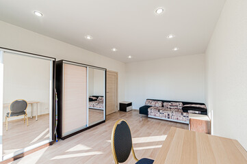 Russia, Moscow- April 28, 2020: interior room apartment bright cozy atmosphere. general cleaning, home decoration, preparation of house for sale. living room with sofa. lamp chandelier on the ceiling