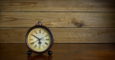 antique hand clock on wooden table - horizontal - close-up