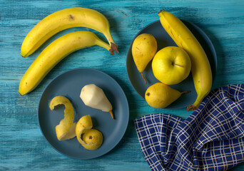 assorted yellow fruits on blue wooden table - closeup