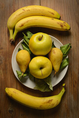 assorted yellow fruits on wooden table - closeup