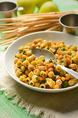 pasta with chickpeas, spinach and carrots - Italian food - closeup