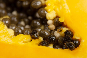 Ripe papaya close-up on yellow background. Fresh fruits and vegetables healthy food