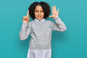 Young little girl with afro hair wearing casual clothes showing and pointing up with fingers number...