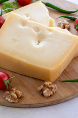 Gruyere cheddar cheese on wooden background. Local name gravyer peynir