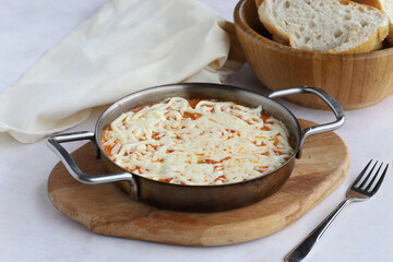 Tomato and peppered egg with melted cheese on wooden background