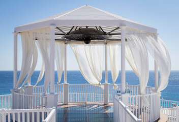 Romantic gazebo on the beach with blue sea