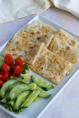 Traditional Turkish food gözleme with cheese and herb. Turkish pancake gozleme concept on the wooden background.