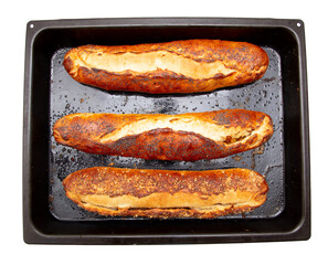 Ruddy buns on a baking sheet isolated on a white background.