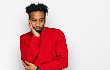 Fototapeta na wymiar Young african american man with beard wearing casual winter sweater thinking looking tired and bored with depression problems with crossed arms.
