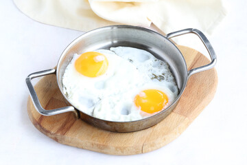 Fried eggs on wooden background