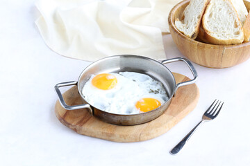 Fried eggs on wooden background