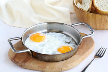 Fried eggs on wooden background