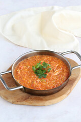 Tomato and peppered egg on wooden background. Local name menemen