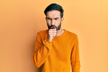 Young hispanic man wearing casual clothes feeling unwell and coughing as symptom for cold or...
