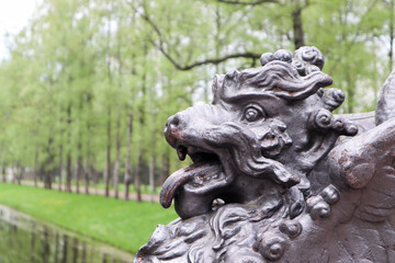 Fototapeta na wymiar lion statue on the bridge in the park springtime