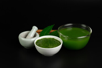Neem used as ayurvedic medicine on black background. Neem is an excellent moisturizing and contains various compounds that have insecticidal and medicinal properties.