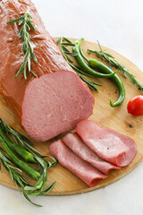 Roast beef on cutting board. Wooden background. Local name sade roast beef