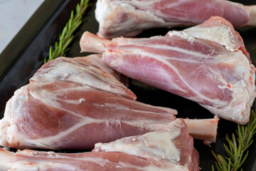 raw Lamb's shank on white wooden background. Close up lamb meat